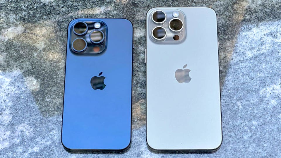 The iPhone 15 Pro & Pro Max laying face down next to one another.